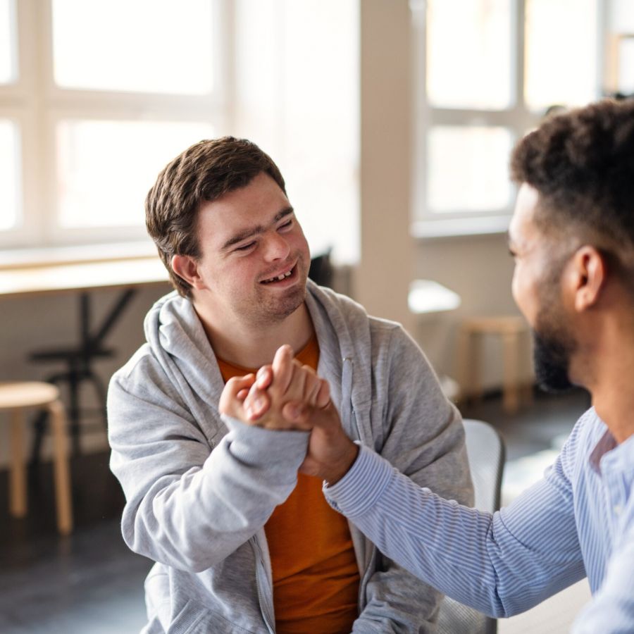 Young,Happy,Man,With,Down,Syndrome,With,His,Mentoring,Friend